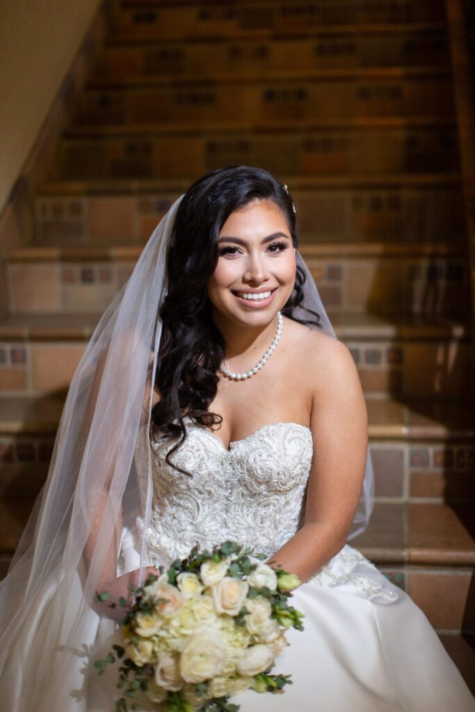 Bridal portrait sitting on staircase, Camille at McNay Art Museum