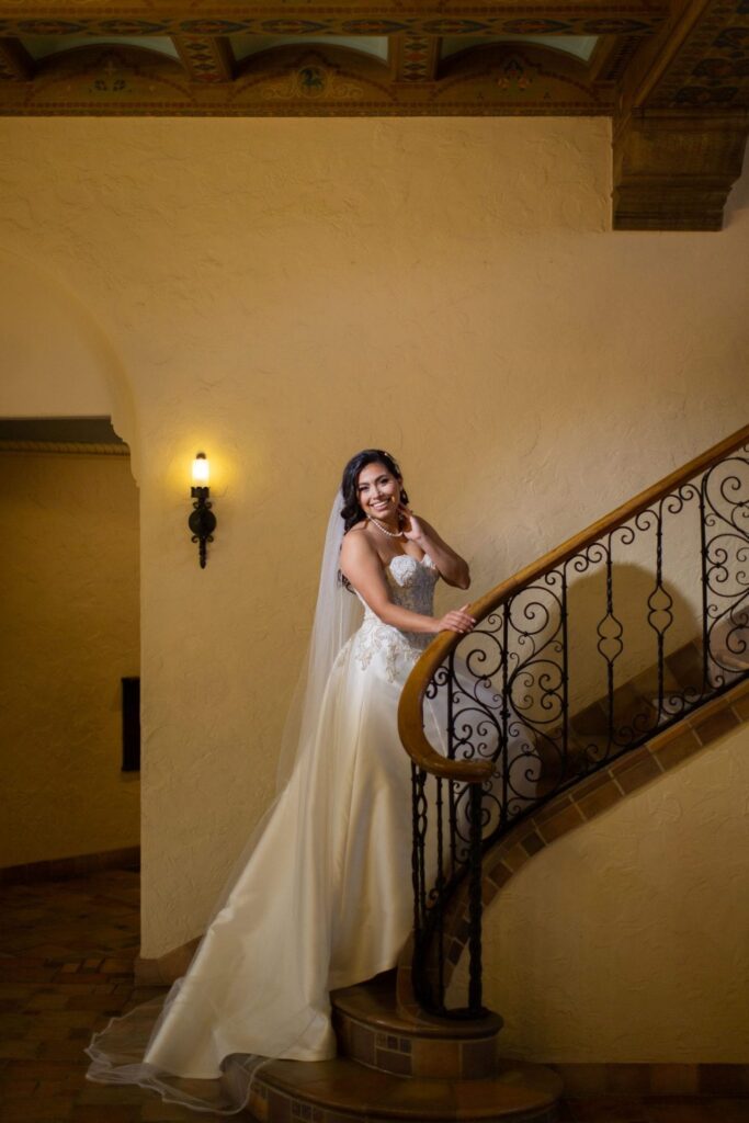 Bridal portrait walking up the staircase, Camille at McNay Art Museum