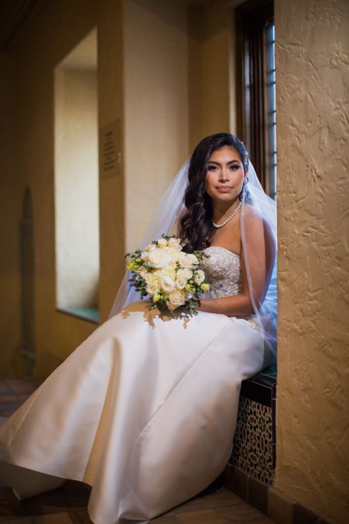 Bridal portrait sitting on the window seat, Camille at McNay Art Museum