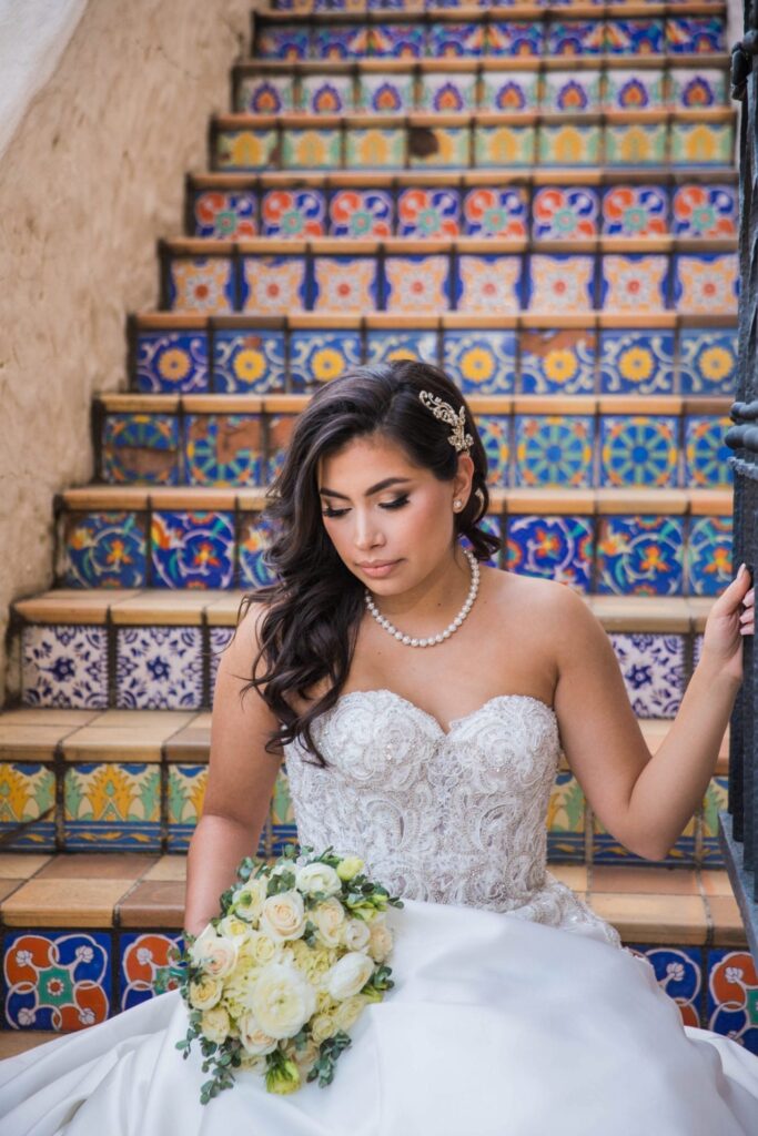 Bridal portrait close up on tile stairs bouquet, Camille at McNay Art Museum