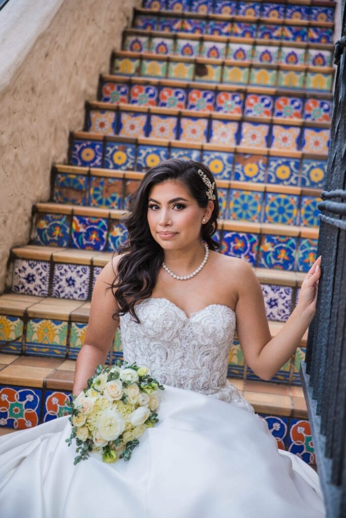 Bridal portrait close up on tile stairs bouquet, Camille at McNay Art Museum