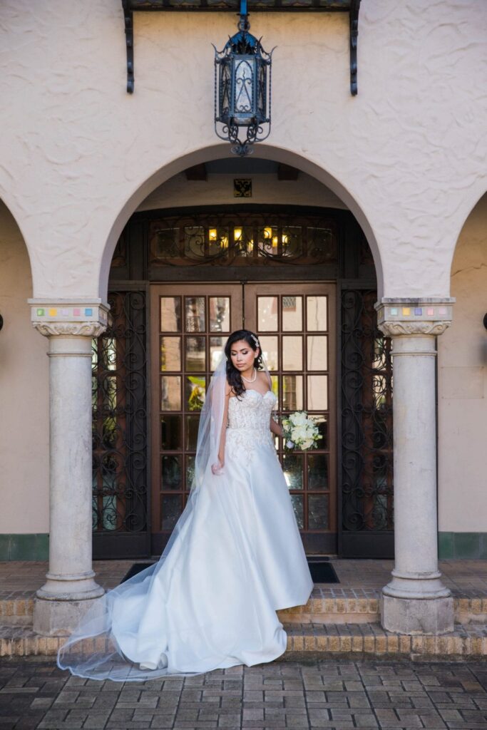 Bridal portrait courtyard arches looking down, Camille at McNay Art Museum