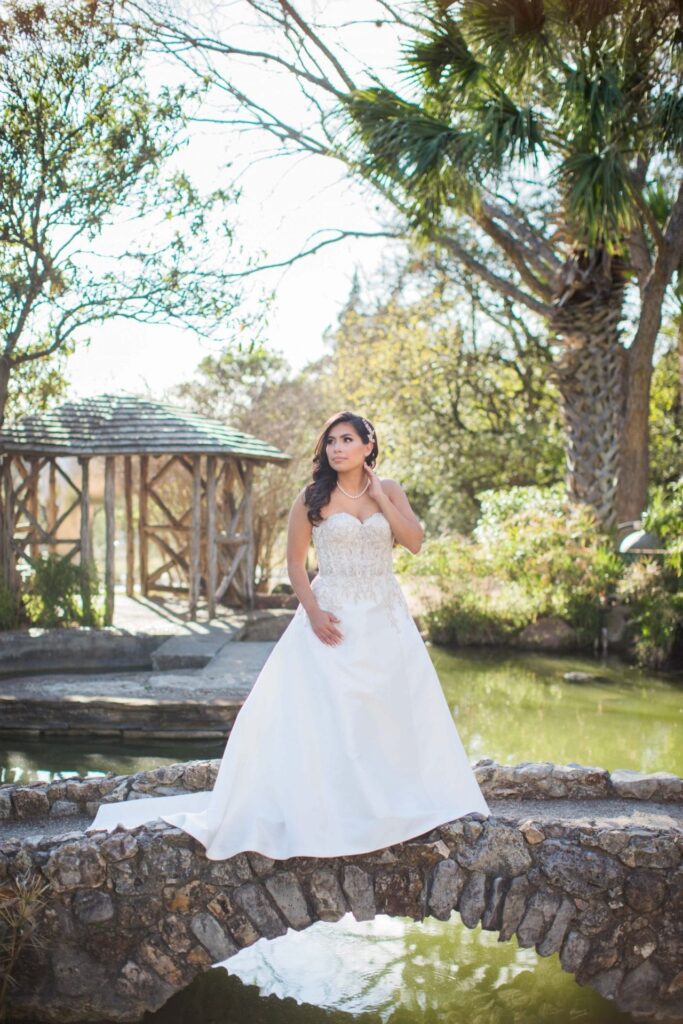 Bridal portrait on the bridge looking up, Camille at McNay Art Museum