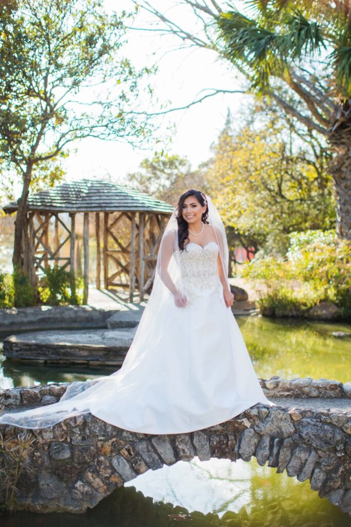 Bridal portrait on the bridge smiling, Camille at McNay Art Museum