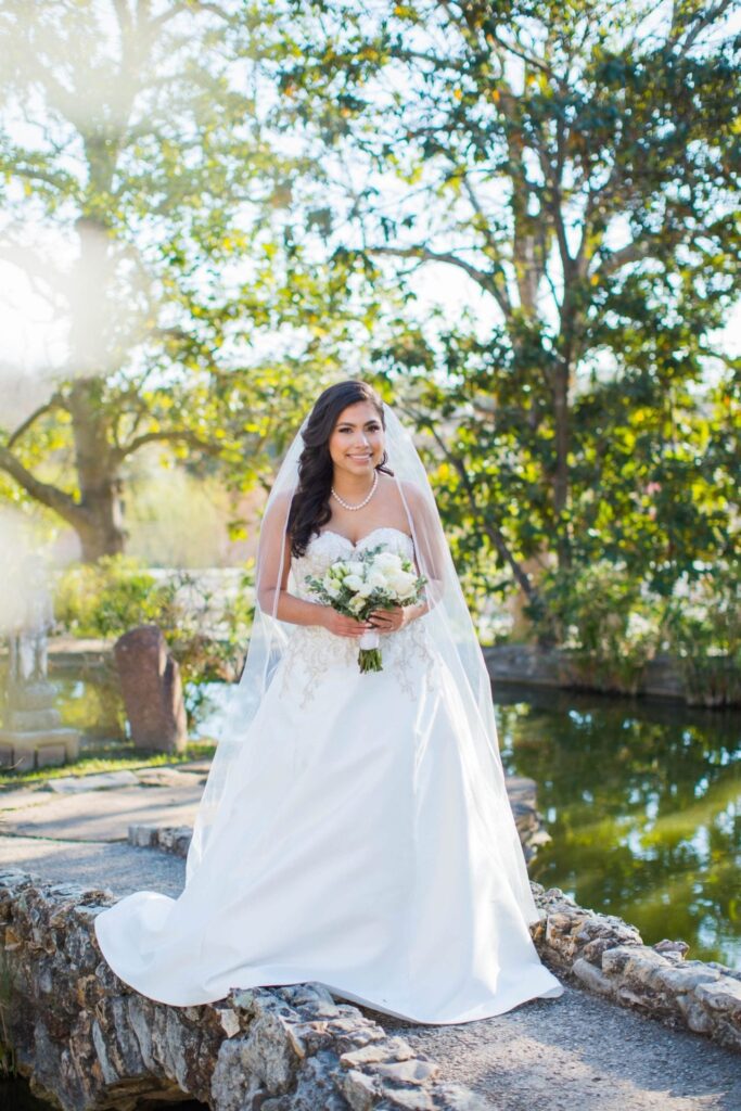 Bridal portrait on the bridge sunny, Camille at McNay Art Museum