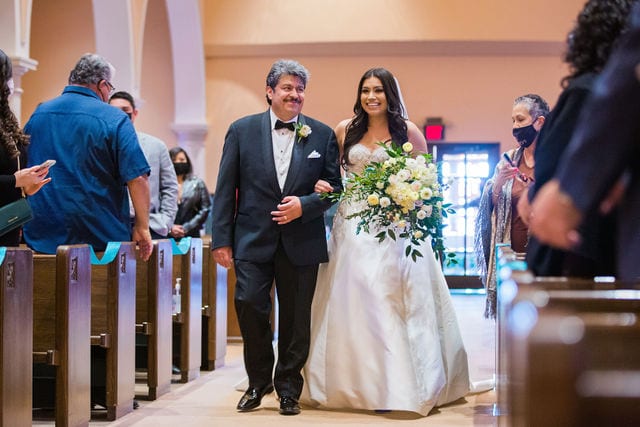 Camille and her father on the aisle at the wedding at the McNay