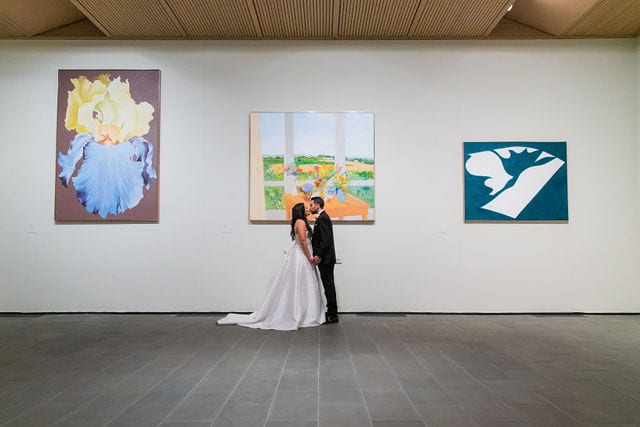 Camille and DJ's kissing in the gallery at the McNay
