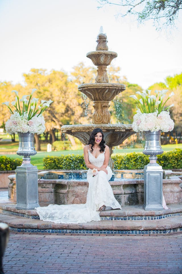 Dominion country club bride sitting on the fountain