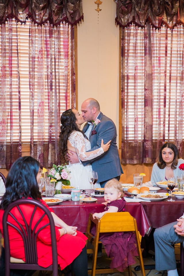 April's San Antonio at the wedding toasts kiss