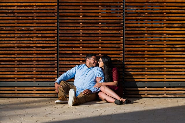 Bethany engagement at Confluence park sitting by wooden wall