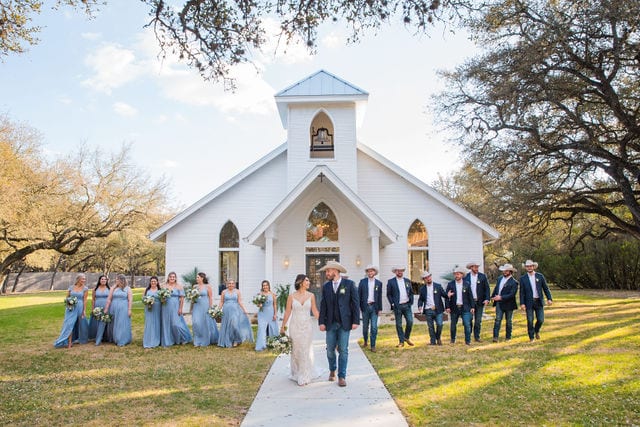 Mariah's wedding Chandelier of Gruene the bridal party walking away from chapel
