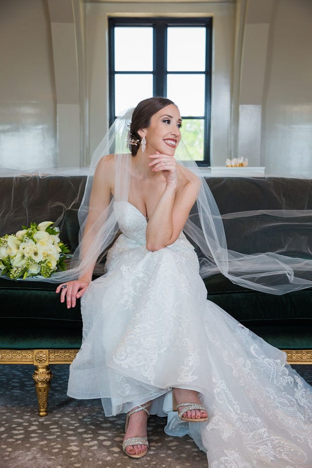 Mary kate bridal at Red Berry Estate sitting on sofa laughing