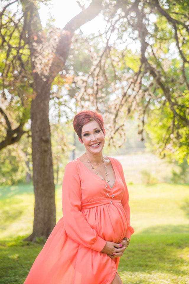 Monique's Maternity session in the grass coral smiling