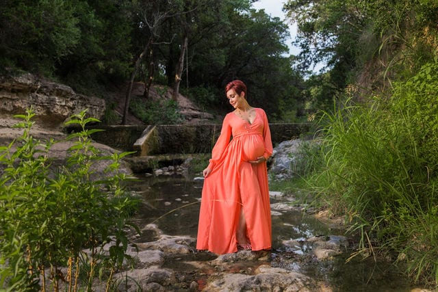 Monique's Maternity session by the dam holding dress