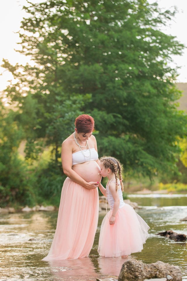Monique's Maternity session in blush in the water tummy kiss