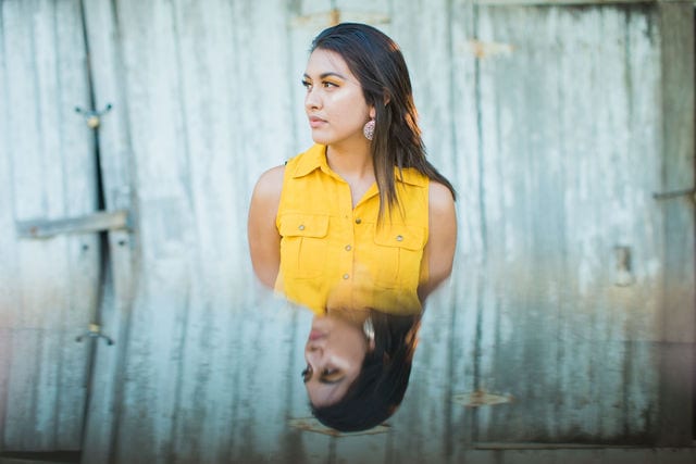 Aubree's Senior session in Gruene reflection by white wall