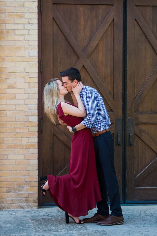 Emily's San Antonio engagement at the Pearl Stable doors dancing kiss