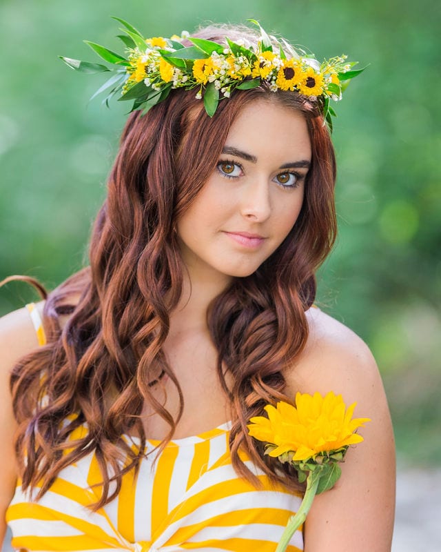 Faith Senior session headshot with flower crown and flower