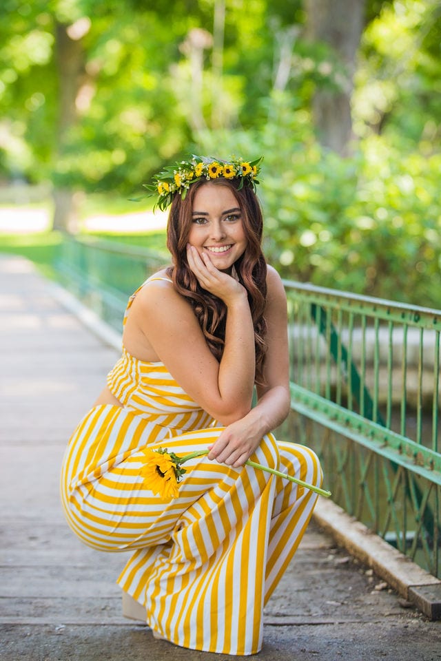 Faith Senior session crouching flower crown and flower