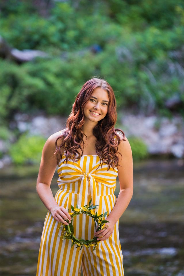 Faith Senior session holding crown by the water Landa Park