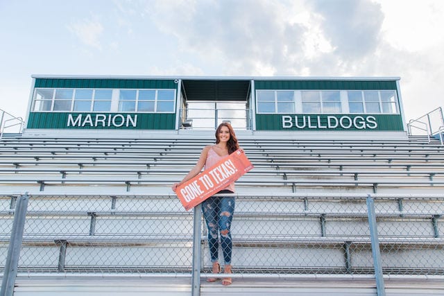 Faith Senior session in Marion holding acceptance sign