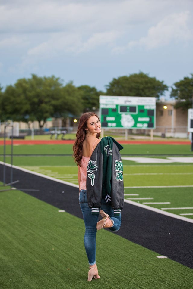 Faith Senior session in Marion on the field walking away