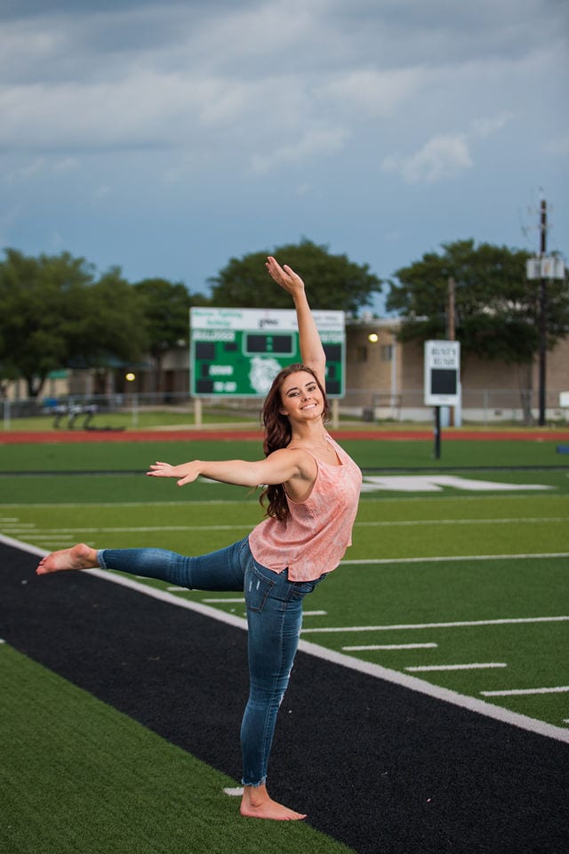 Faith Senior session in Marion dancing on the field