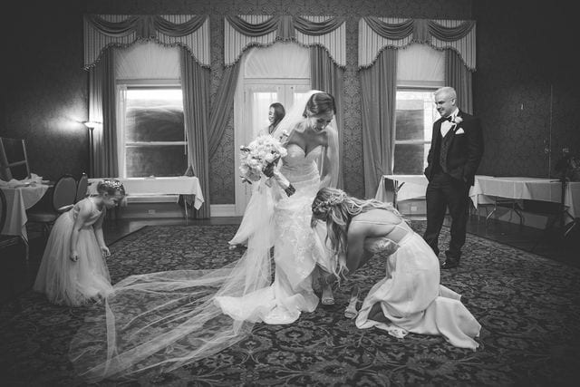 Spenser wedding San Antonio the Menger bridesmaid helping dress the bride