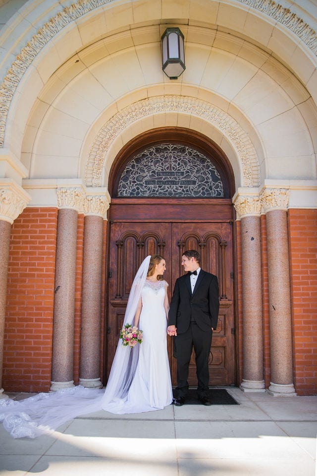 Olivia wedding at University of the Incarnate Word hand-holding at doors