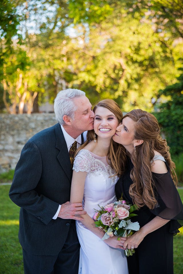 Olivia wedding at southwest school of Art bridal parents kiss