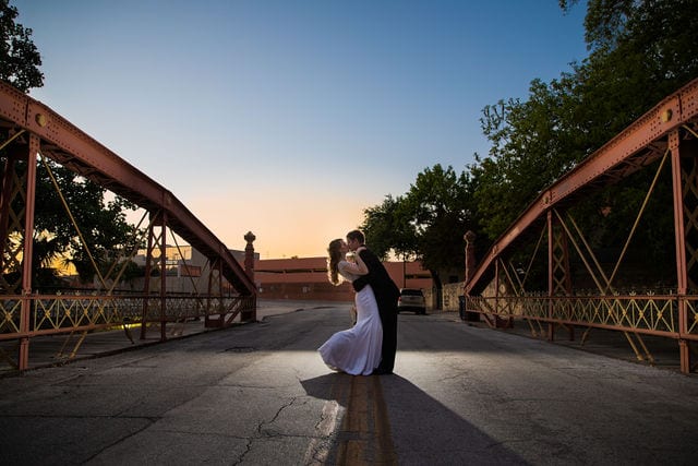 Olivia wedding at southwest school of Art sunset on the bridge kiss