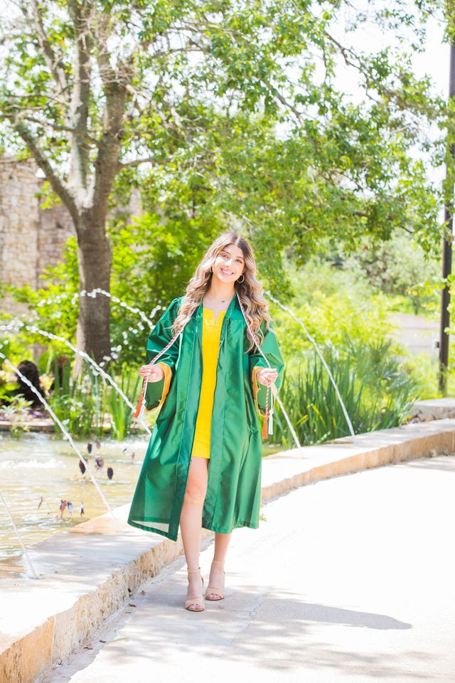 Hailey's senior session at San Antonio Botanical Gardens walking by fountain