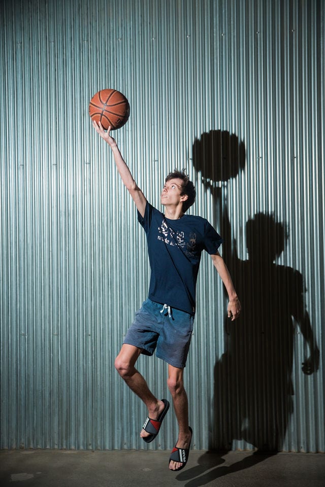 Wyatt's senior session the Pearl in wall with basketball jumping