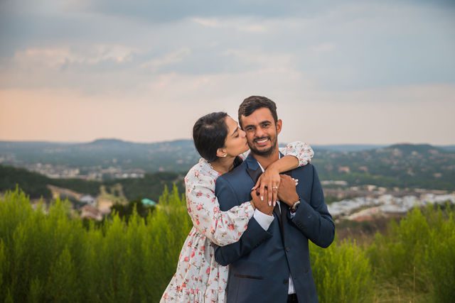 Rishi and Sahis San Antonio proposal engagement on the hill kiss on the cheek