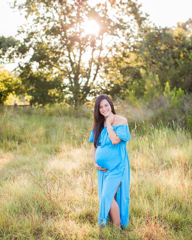 Stefan maternity Cibolo Natural Area Ashley in the grass laughing