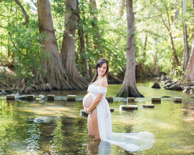 Stefan maternity Cibolo Natural Area Ashley in white in the river by steps
