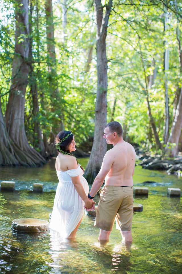 Stefan maternity Cibolo Natural Area Ashley in white in the river walking away