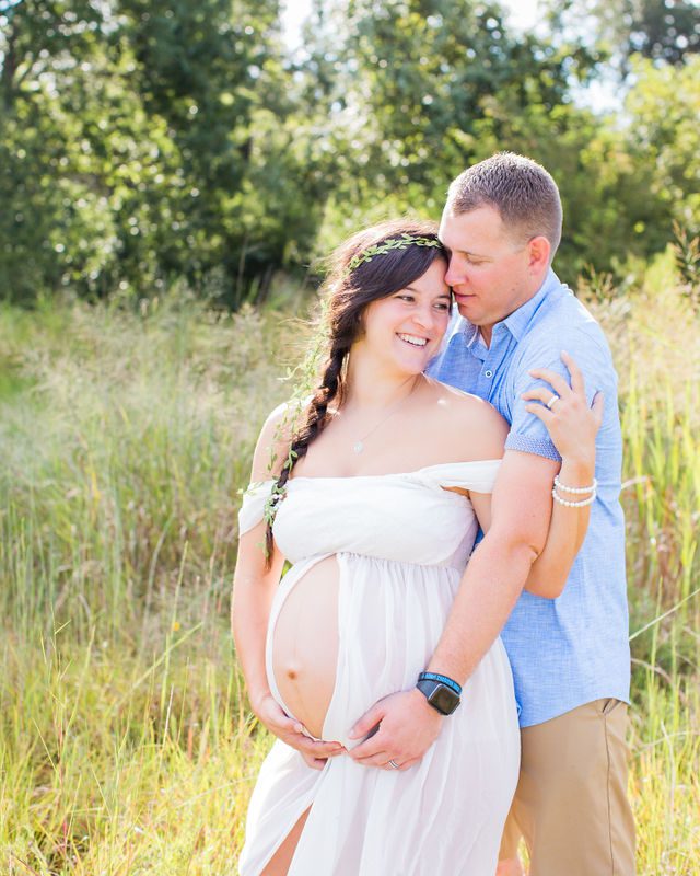 Stefan maternity Cibolo Natural Area couple in white in the grass laughing