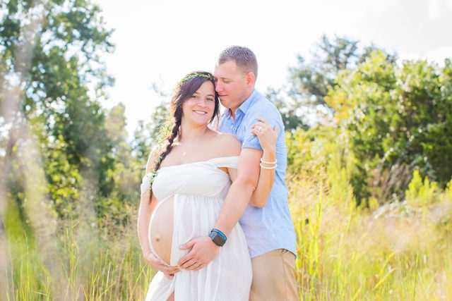 Stefan maternity Cibolo Natural Area couple in white in the grass with sky