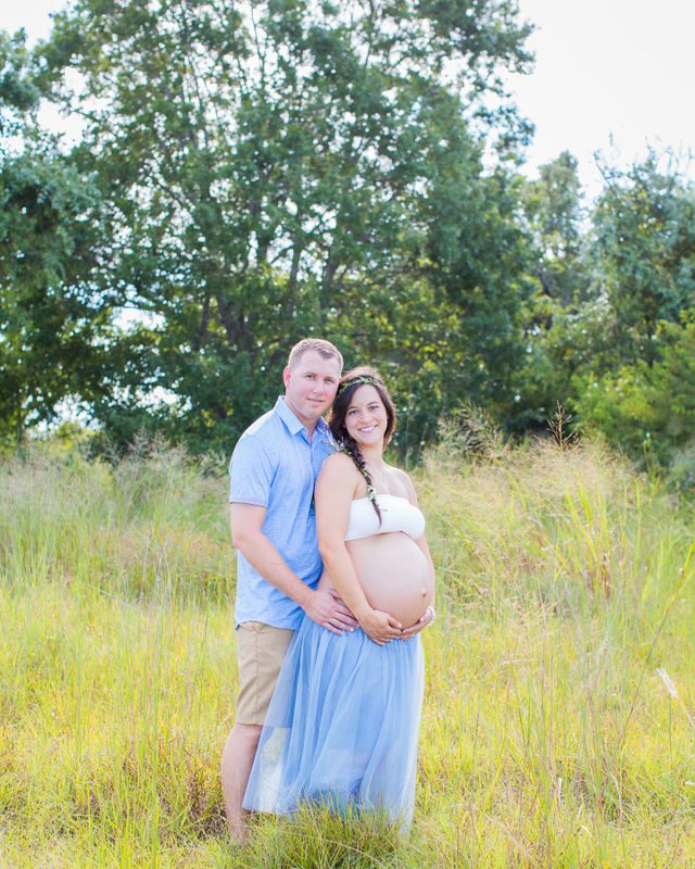 Stefan maternity Cibolo Natural Area couple in a tutu in the grass holding baby