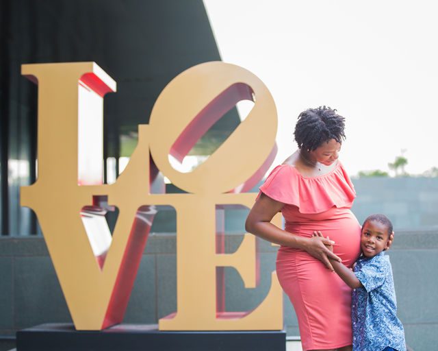 Shara maternity McNay Art Museum mommy and son by the love sign