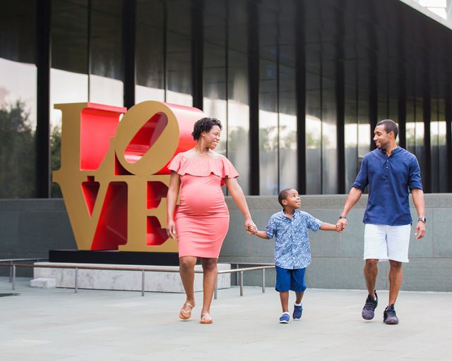 Shara maternity McNay Art Museum walking by the Love sign