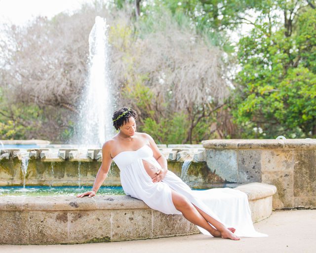 Shara maternity McNay Art Museum sitting white dress on the fountain