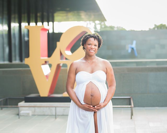 Shara maternity McNay Art Museum the belly in white with LOVE sign