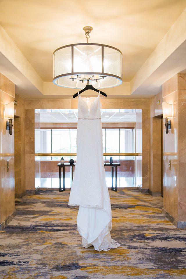 Ophir wedding in San Antonio the gown hanging in the hotel lobby