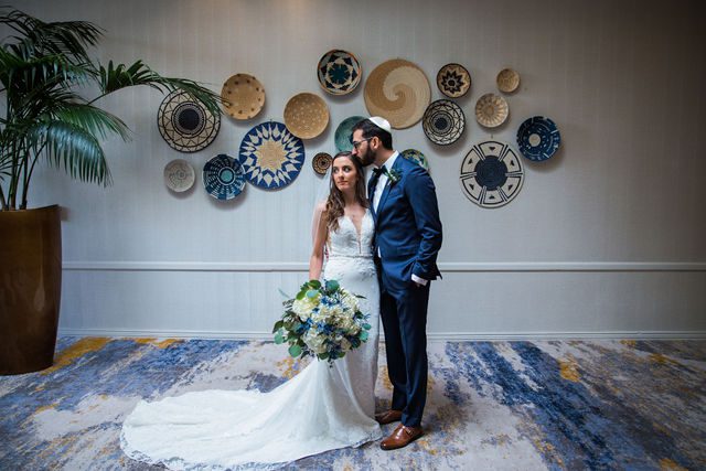 Ophir wedding in San Antonio the bride and groom portrait with plates in the hall