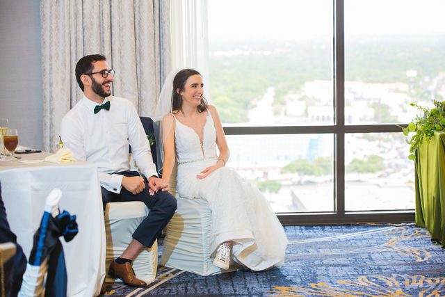 Ophir's San Antonio wedding reception bride and groom watch the slideshow