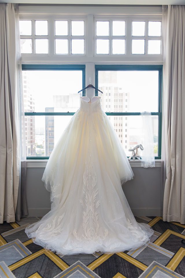 Shannon wedding at St Anthony Hotel Starlight Suite dress in the window