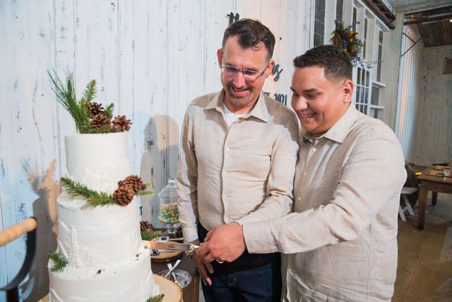 Will and Ross's cake cutting at harper hills ranch wedding reception