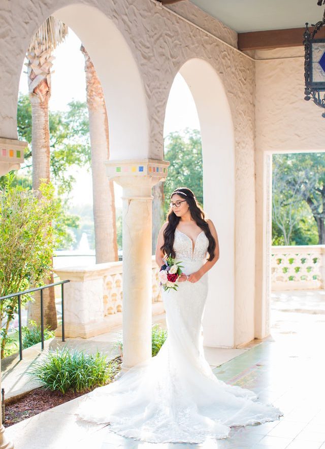 Bethany's bridal portrait at the McNay in the arches looking down